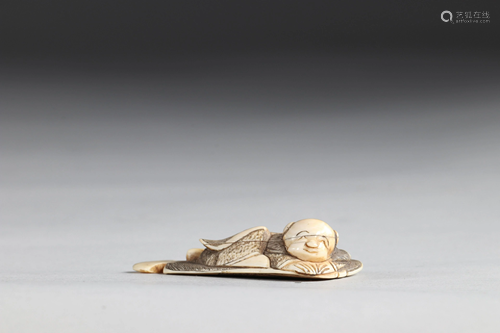 Netsuke carved - a reclining child. Japan Meiji period