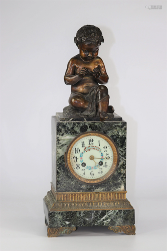 Marble clock surmounted by a bronze child