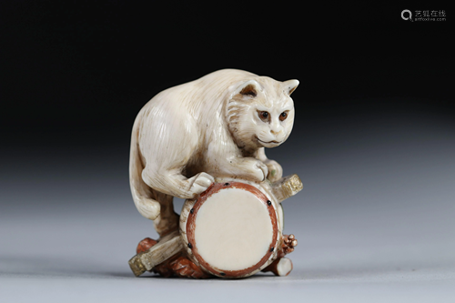 Netsuke carved - a cat on a drum. Japan early 20th