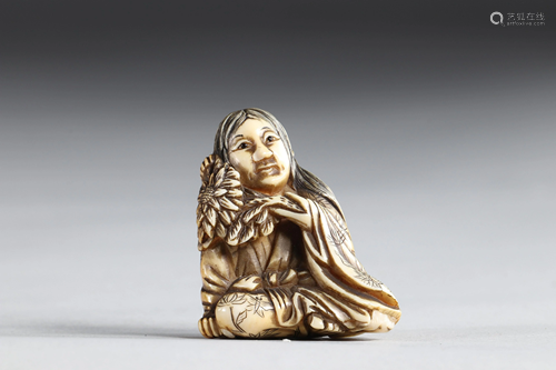 Netsuke carved - a woman holding a flower. Japan Meiji