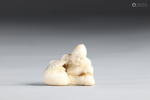 Netsuke carved - a seated figure. Japan Meiji period