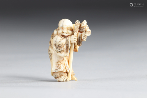 Netsuke carved - a sage carrying a miniature man. Japan