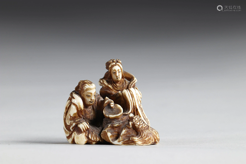 Netsuke carved - figures feeding a feathered turtle.