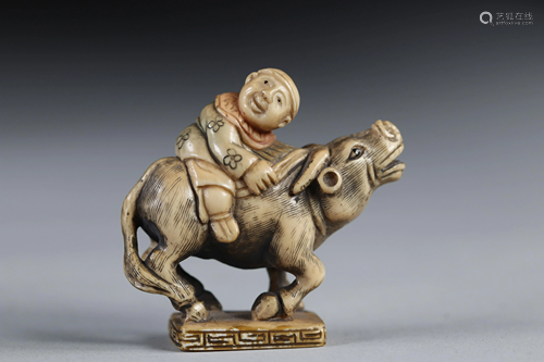 Netsuke carved - a character on a buffalo. Japan early