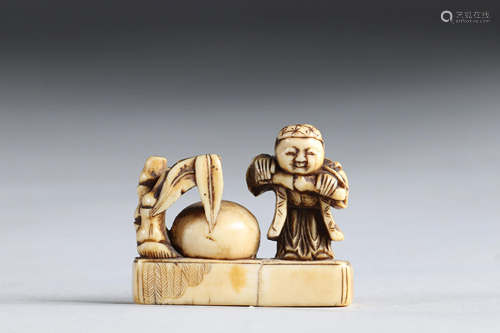 Netsuke carved - a figure and a giant fruit; Japan Edo