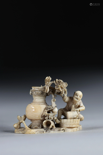 Netsuke carved - a figure picking fruit. Japan Meiji