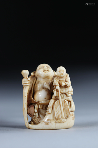 Netsuke carved - a Buddha holding a child. Japan Meiji