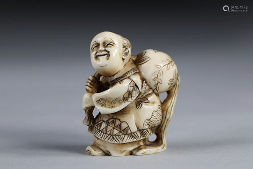 Netsuke carved - a figure carrying a sack. Japan Meiji