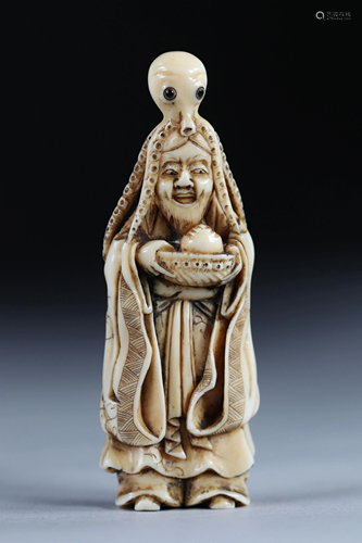 Netsuke carved - a woman wearing an octopus. Japan