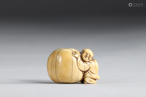 Netsuke carved - a figure pushing a rock. Japan Meiji