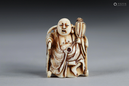 Netsuke carved - a Buddha seated on a throne. Japan