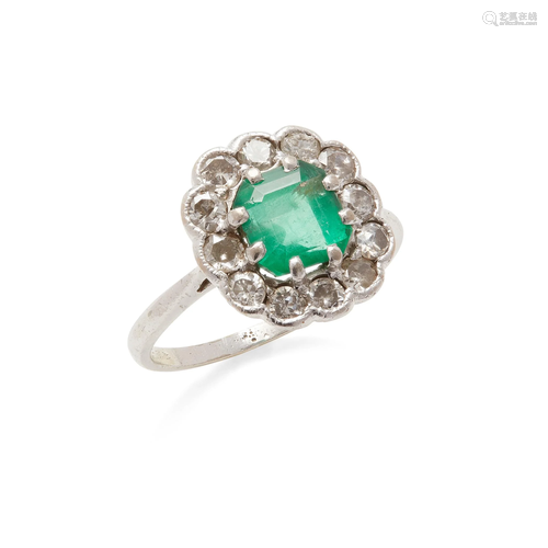 An emerald and diamond cluster ring