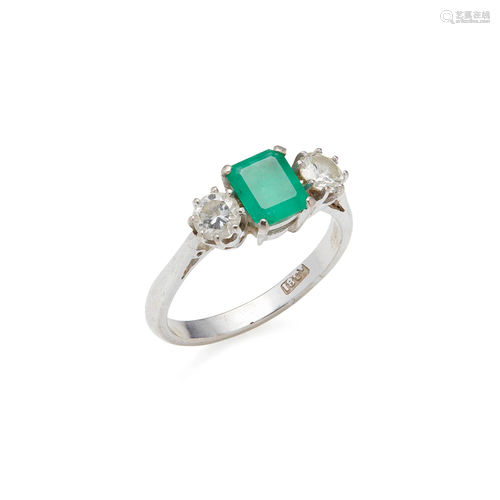 An emerald and diamond three stone ring