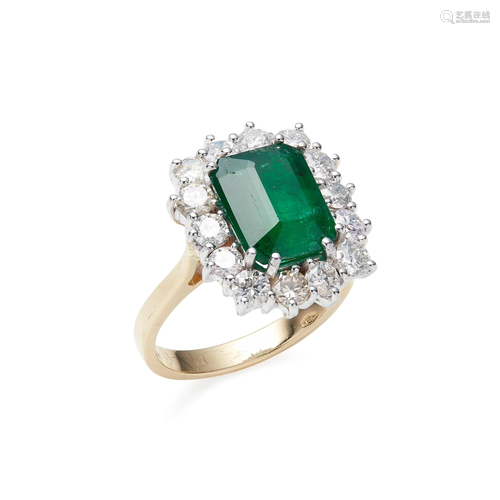 An emerald and diamond set cluster ring