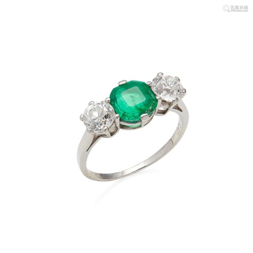 An emerald and diamond set three stone ring