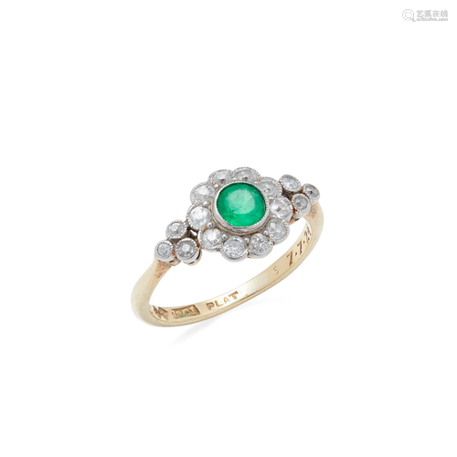 An emerald and diamond set cluster ring