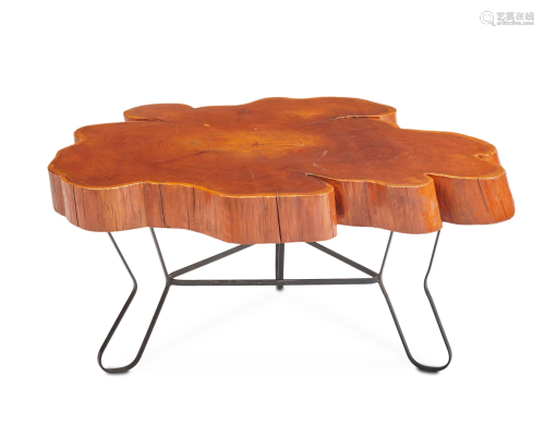 A free-form natural wood and iron cocktail table