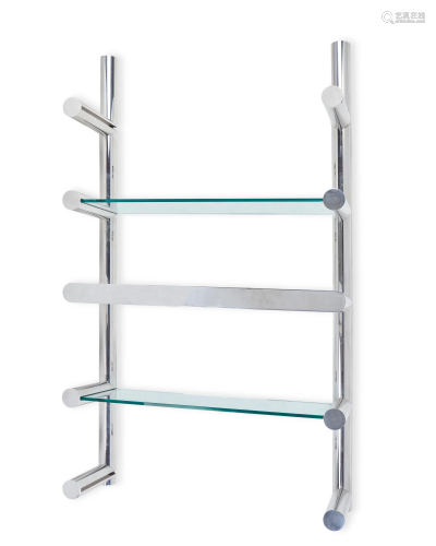 A lighted wall-mounted chrome and glass shelving system