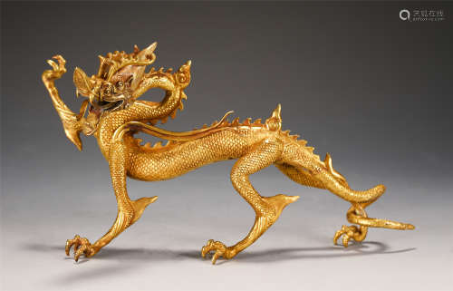 A CHINESE GOLD DRAGON SHAPED DECORATION