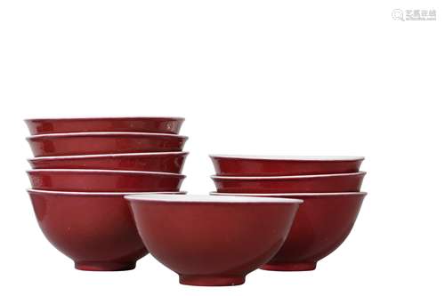 A SET OF NINE SMALL CHINESE COPPER RED-GLAZED BOWLS.