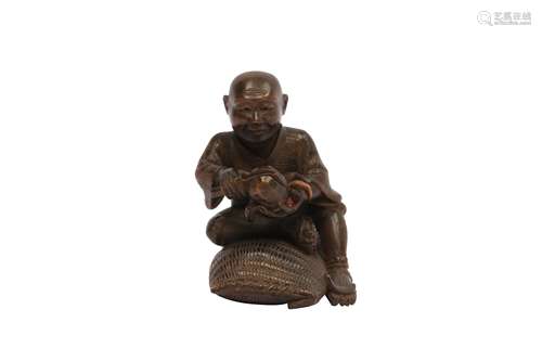 A WOOD NETSUKE OF A FARMER.