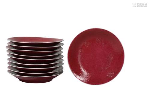 A SET OF TEN CHINESE COPPER RED-GLAZED DISHES.