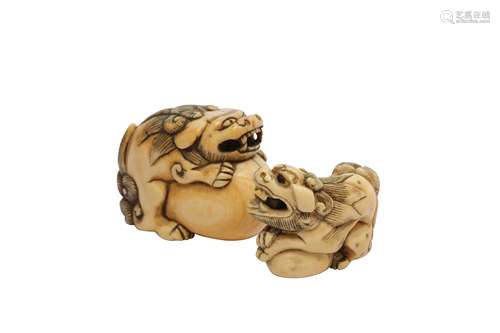 TWO IVORY SHISHI DOG NETSUKE.