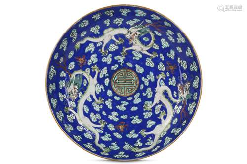 A CHINESE FAMILLE ROSE BLUE-GROUND 'DRAGON' DISH.