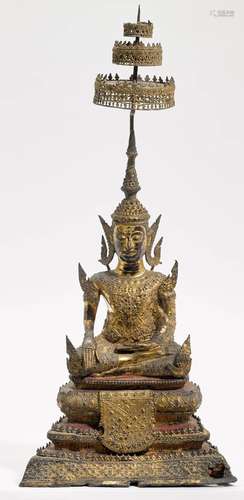 A BRONZE FIGURE OF A SEATED BUDDHA WITH PARASOL.