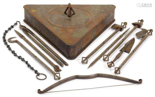 A SET OF RITUAL INSTRUMENTS IN A TRIANGLE-SHAPED BOX.