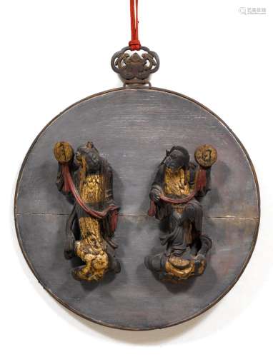A WOOD ROUNDEL WITH TWO IMMORTALS HOLDING SUN AND MOON.