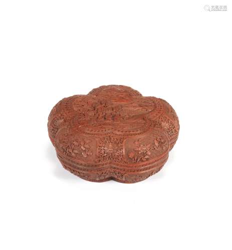 A CARVED CINNABAR LACQUER PRUNUS-FORM BOX AND COVER Qianlong...