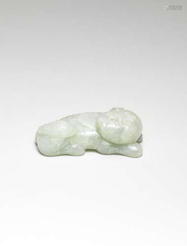 A PALE GREEN JADE CARVING OF A BUDDHIST LION Ming Dynasty