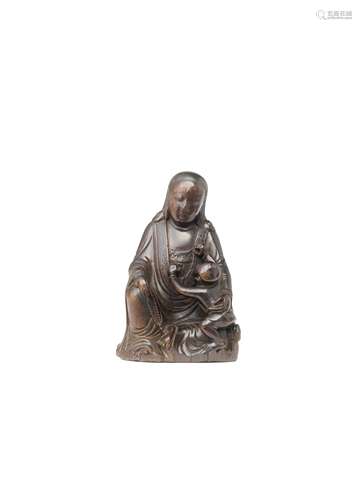 A CARVED WOOD FIGURE OF GUANYIN AND CHILD 17th century