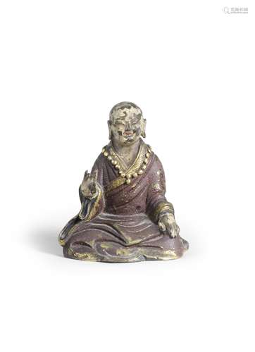 AN UNUSUAL GILT AND COLD-PAINTED BRONZE FIGURE OF A LUOHAN 1...