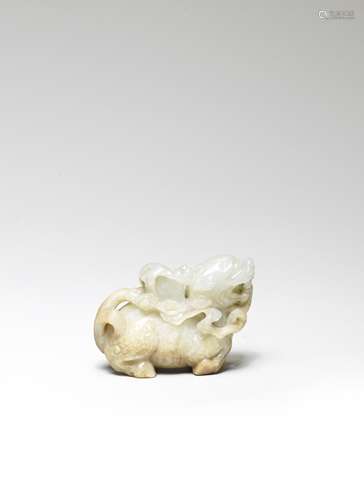 A PALE GREEN AND RUSSET JADE CARVING OF A QILIN CARRYING BOO...