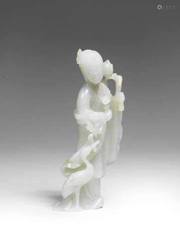 A VERY PALE GREEN JADE FIGURE OF HE XIANGU 17th/18th century...