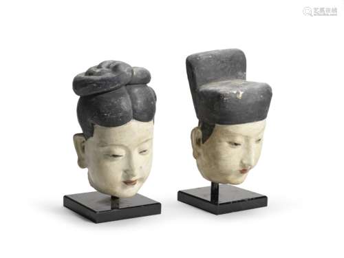 A RARE PAIR OF PAINTED STUCCO HEADS OF MALE AND FEMALE OFFIC...