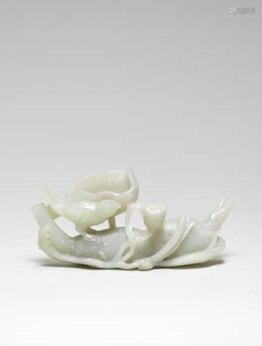 A PALE GREEN JADE CARVING OF A LOTUS ROOT AND BIRD 18th cent...