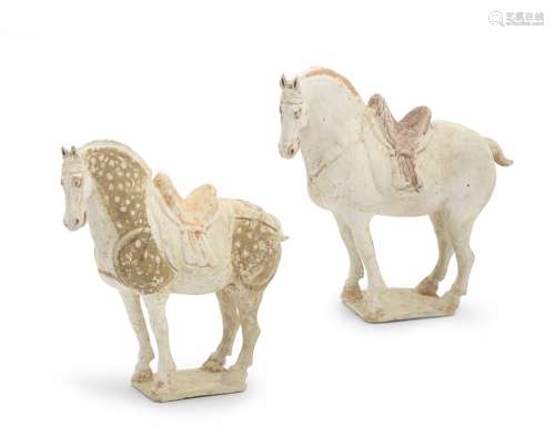 TWO PAINTED POTTERY MODELS OF CAPARISONED HORSES Tang Dynast...