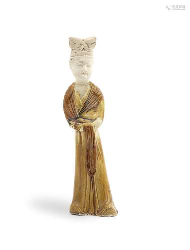 AN AMBER-GLAZED POTTERY FIGURE OF A LADY Tang Dynasty