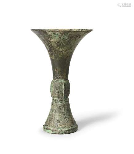 A RARE ARCHAIC BRONZE RITUAL WINE VESSEL, GU Late Shang Dyna...