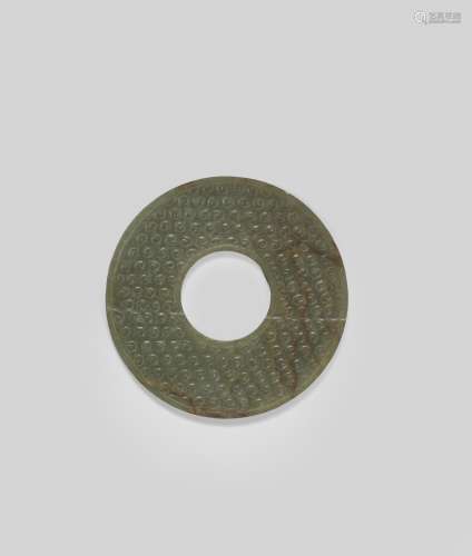 AN ARCHAIC GREEN AND RUSSET JADE DISC, BI Warring States Per...