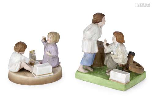 Two porcelain pen rests modelled as groups of playing childr...