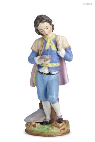 A large porcelain figure of a young page boy holding a bird ...