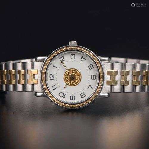 HERMÈS. Montre bracelet de dame en acier et métal doré modèl...