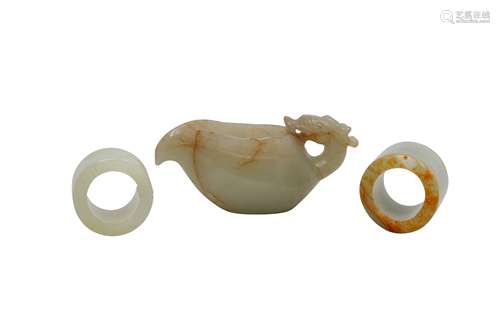 A CHINESE PALE CELADON POURING VESSEL AND TWO ARCHER'S RINGS...