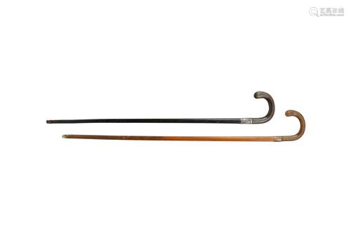 λ TWO RHINOCEROS HORN HANDLED WALKING STICKS.