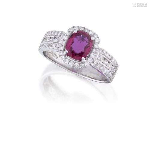 A ruby and diamond ring, the cushion-shaped ruby, weighing a...