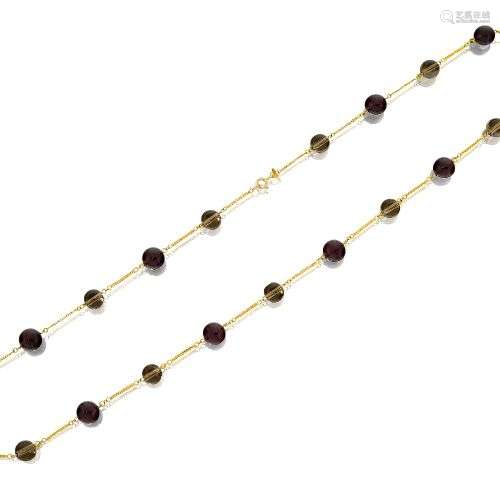 A garnet and smoky quartz necklace, composed of a line of al...